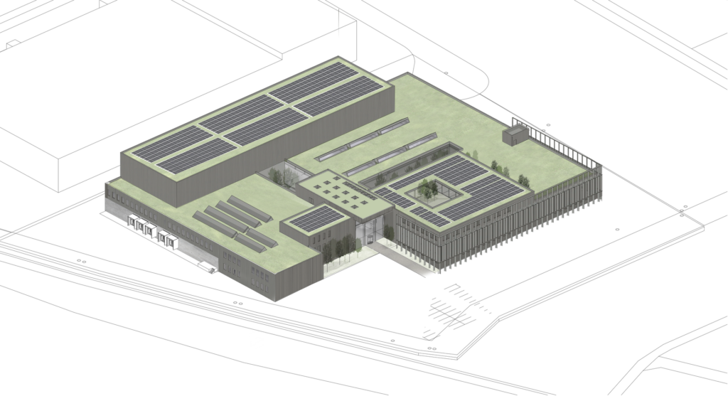 Luftaufnahme eines modernen, flachgedeckten Gebäudes mit begrüntem Dach und Solarpaneelen, umgeben von Zaun.